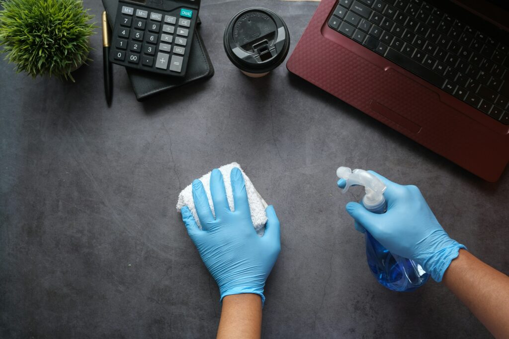 Lany Cleaning professional sanitizing an office workspace desk in Tampa Bay